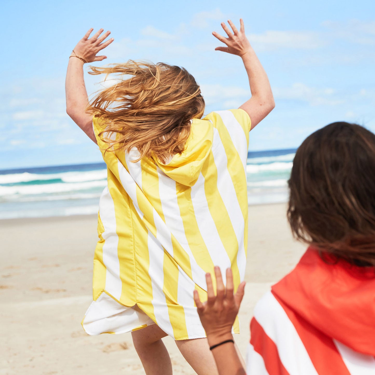 Girls on beach in Poncho